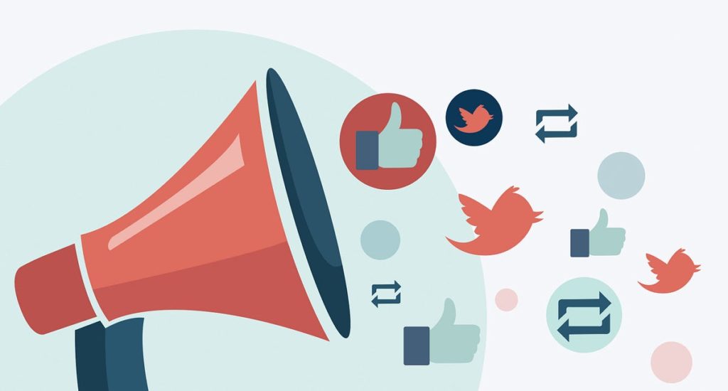 A graphic of a megaphone with social media logos and icons coming out of it. The icons include the twitter bird and a thumbs up icon.