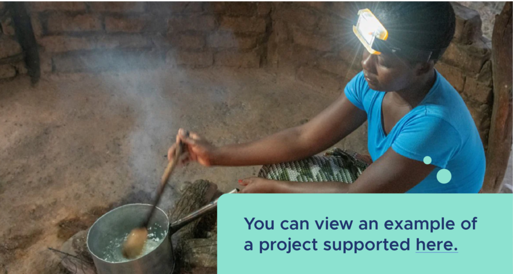 A woman in a blue shirt cooks over a small fire. She is wearing a headlamp. A caption reads, "You can view an example of a project supported here."